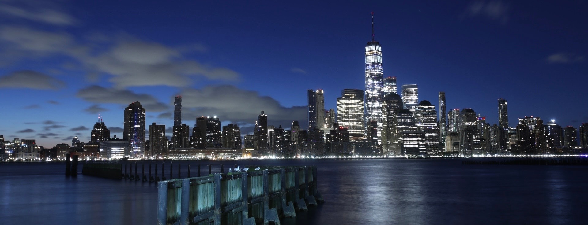 Manhattan skyline illuminated at dusk