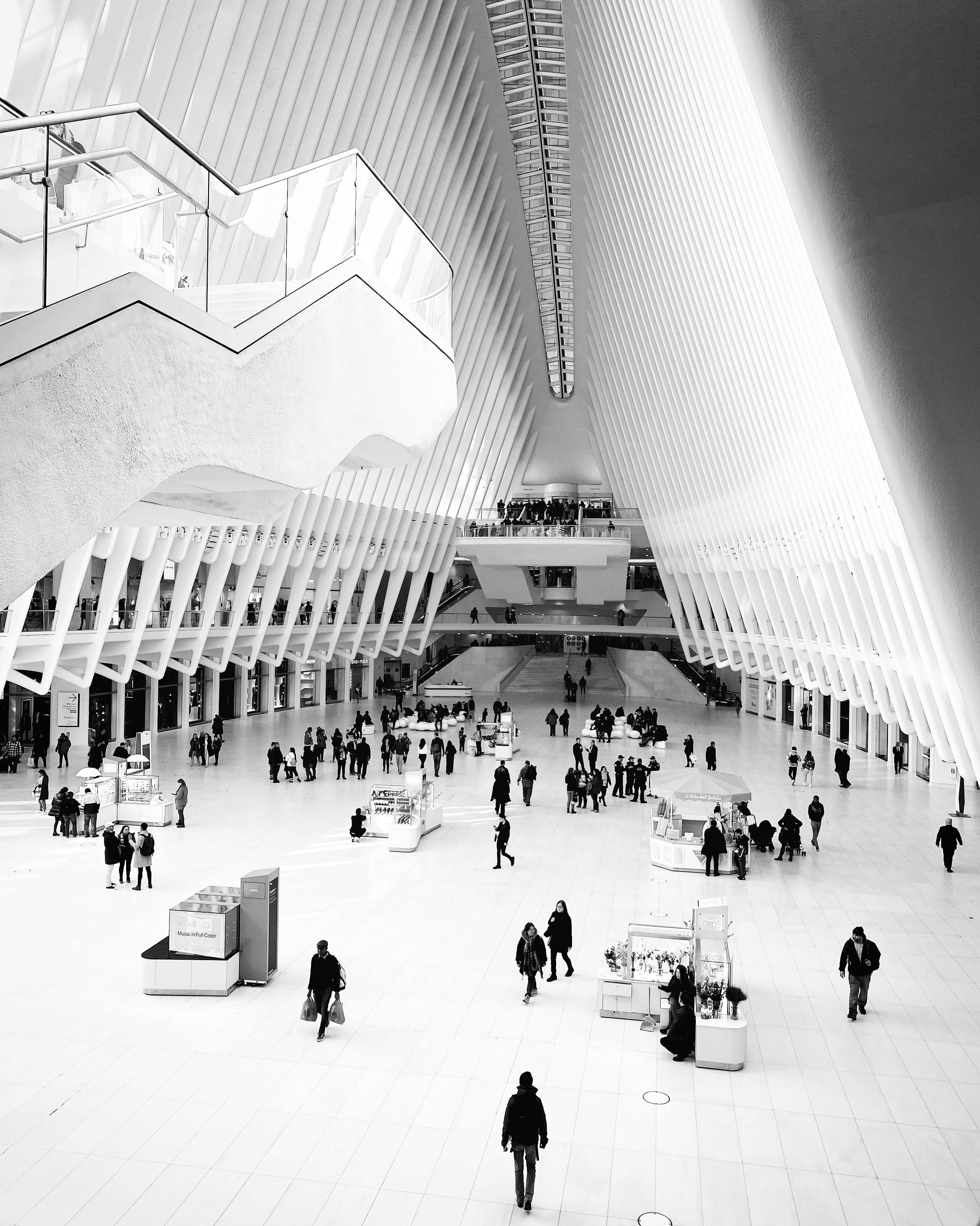 The Oculus at World Trade Center interior with dramatic ribbed white architecture and commuters