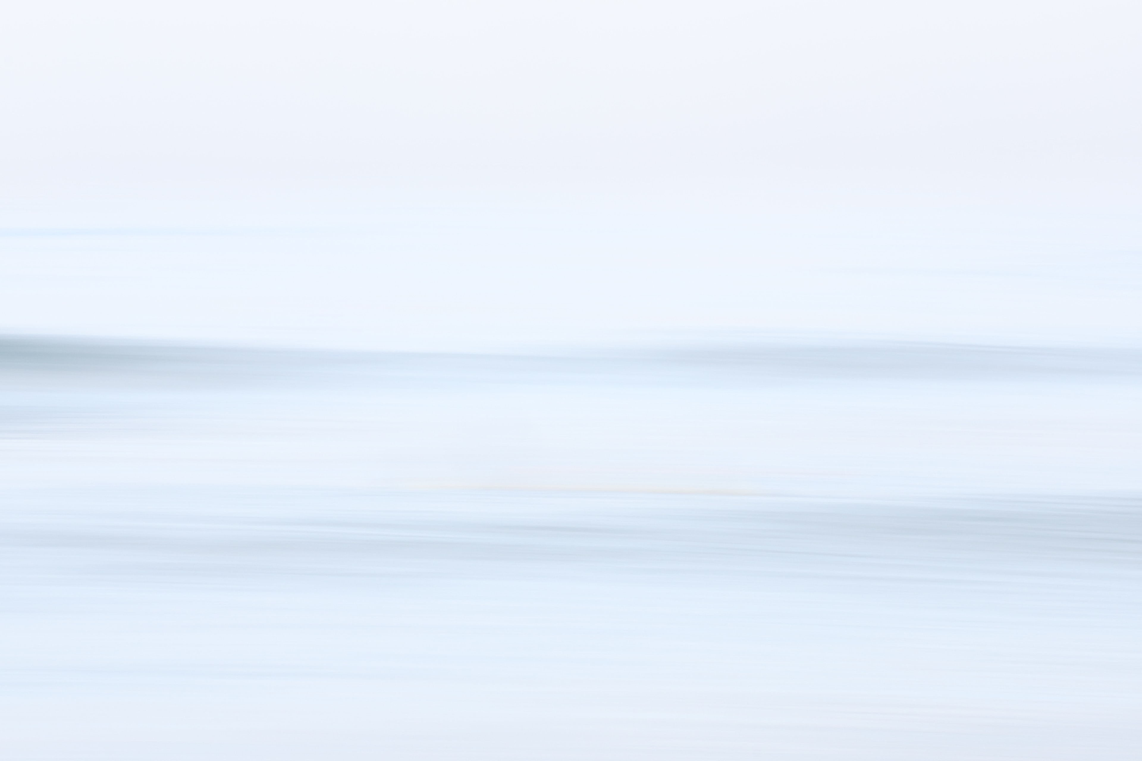 Abstract seascape with soft blurred horizon and pale blue tones